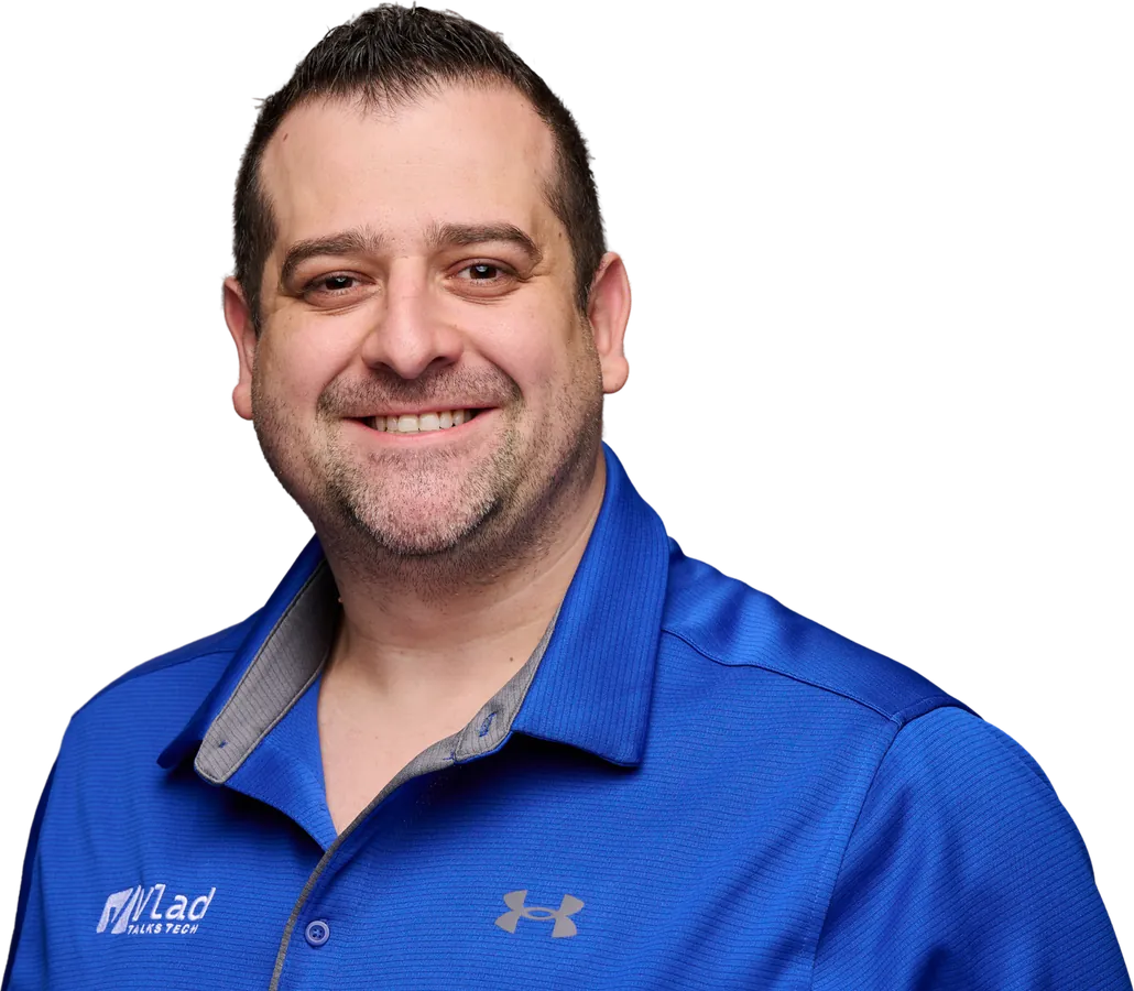 Vlad Catrinescu smiling in a blue Vlad Talks Tech polo