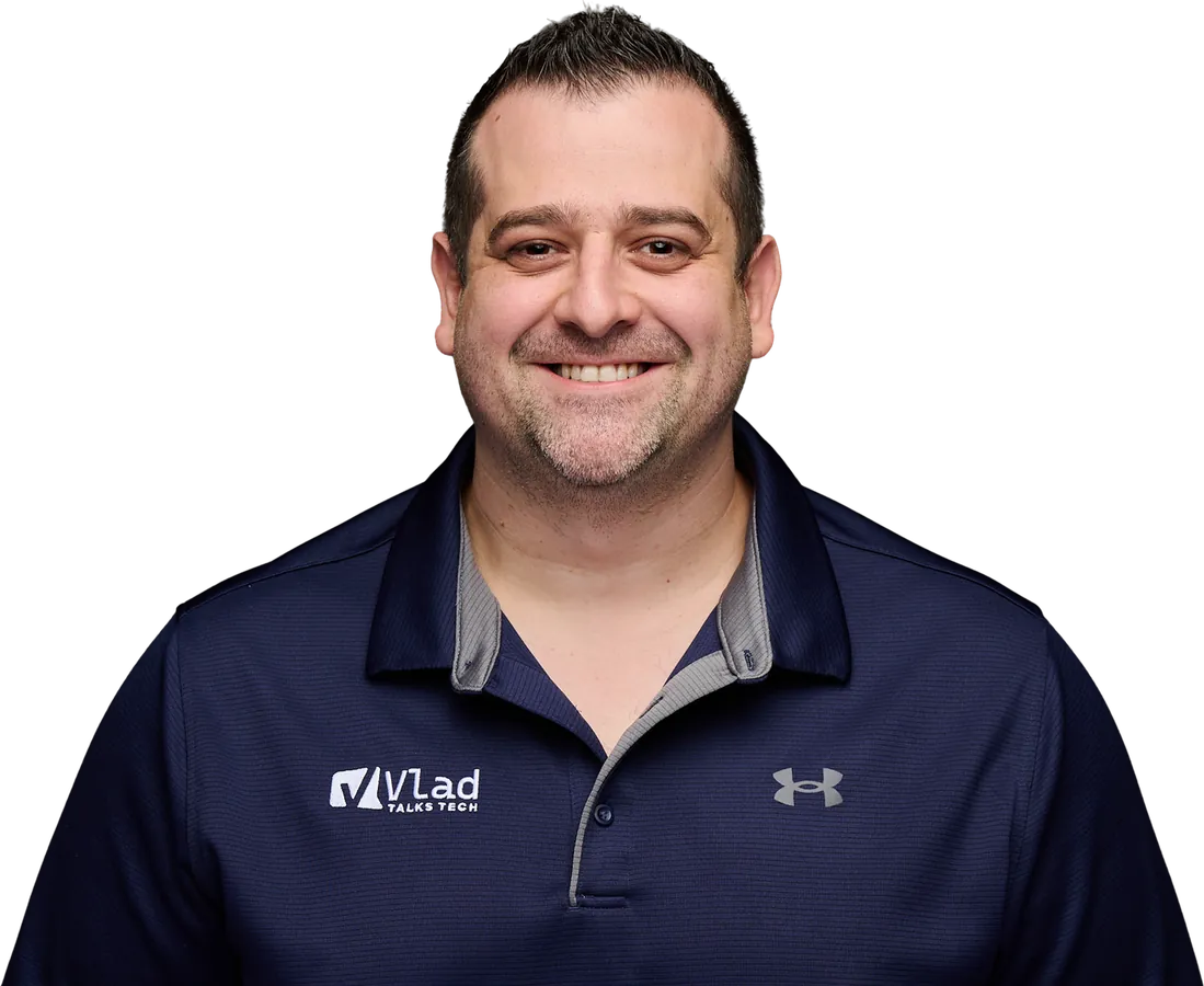 Vlad Catrinescu in a dark blue Vlad Talks Tech polo, ready to point you straight to the answer