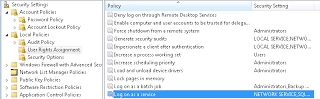 Local Security Policy console under User Rights Assignment with the Log on as a service policy selected