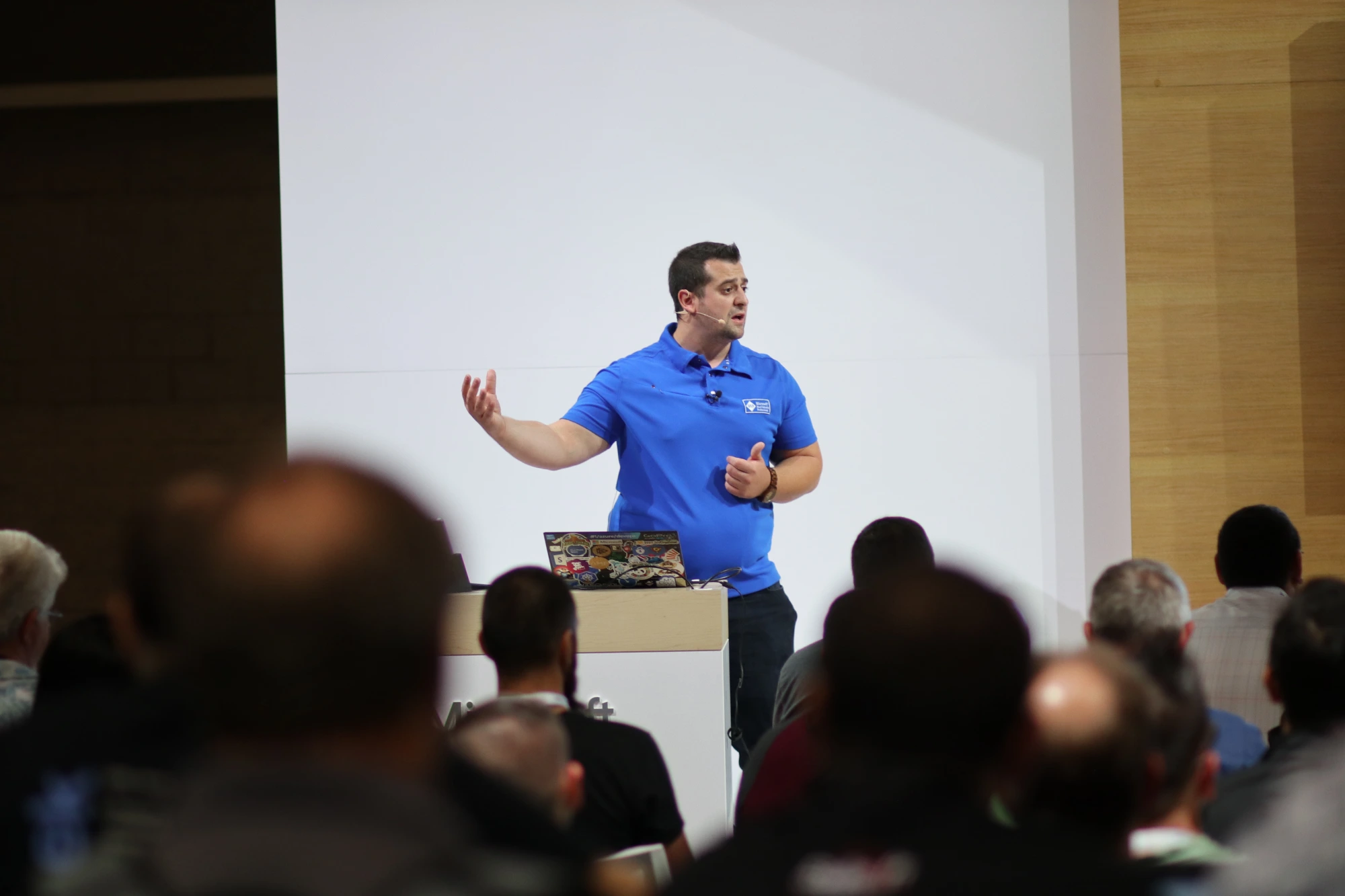 Vlad Catrinescu presenting on stage at Microsoft Ignite 2018 in Orlando, in front of a seated audience