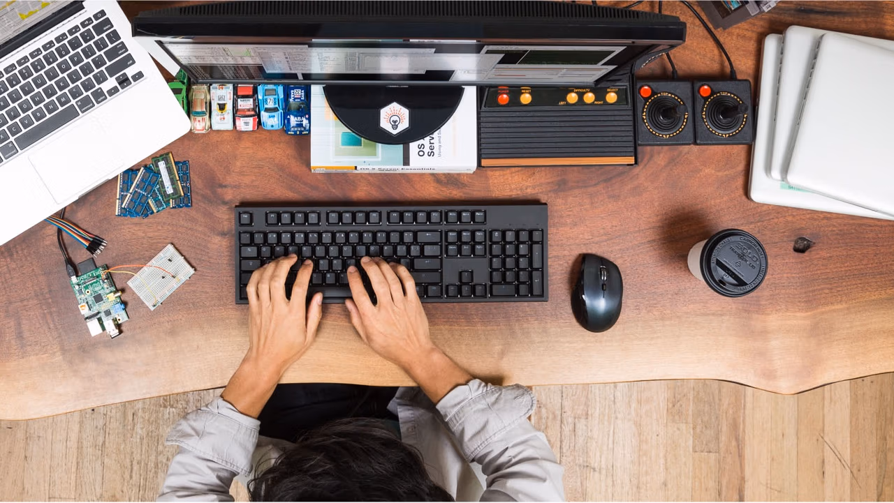 Pluralsight course artwork for SharePoint 2016 Logical Architecture: a desk seen from above with a keyboard and gadgets