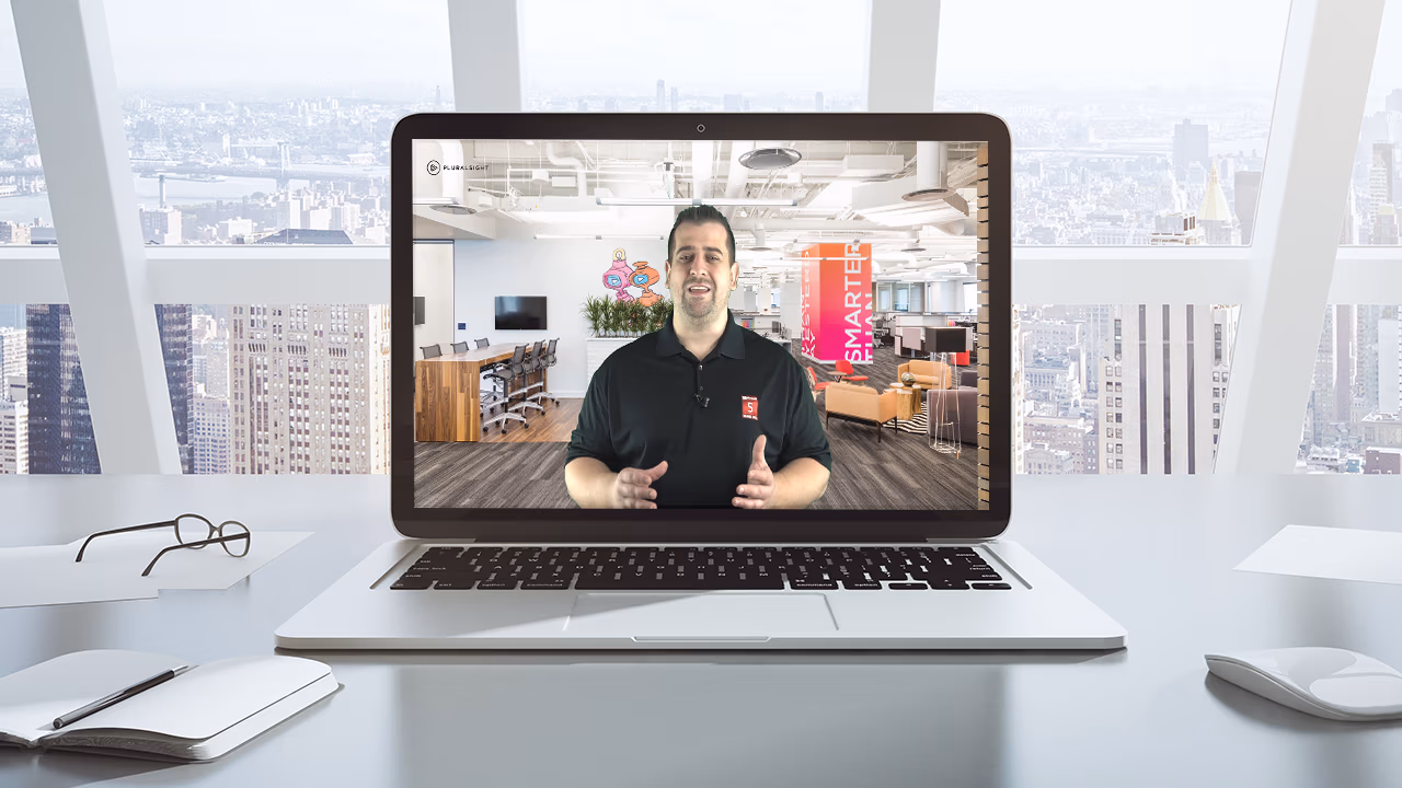 Pluralsight course artwork for the Mobile Device Management briefing: Vlad presenting on a laptop screen in an office