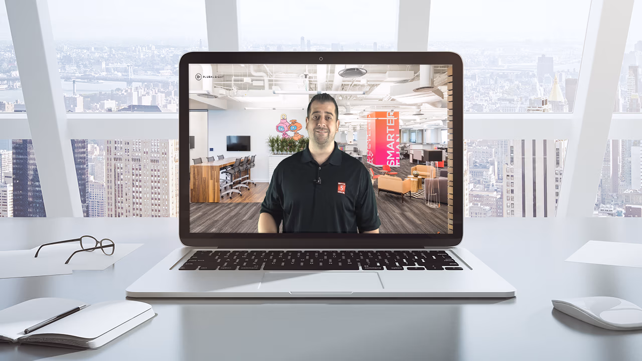 Pluralsight course artwork for the RPA and Workflow Automation briefing: Vlad presenting on a laptop screen in an office